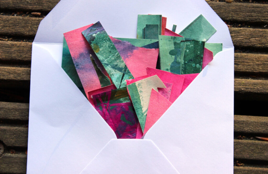 White envelope with colourful collage papers.